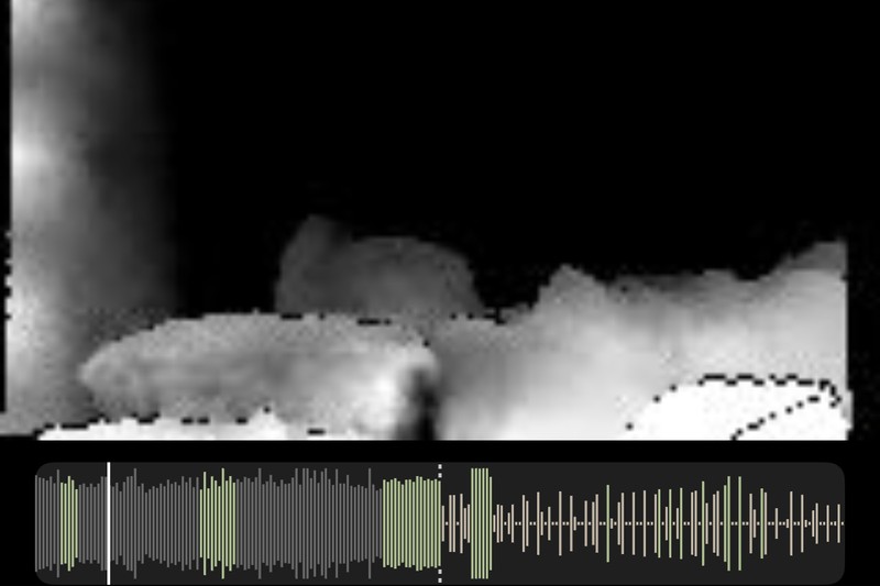 An infrared depth frame recorded in a fully dark bedroom: a sleeper’s outline rendered in greyscale.